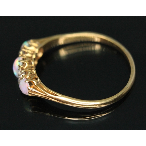 230 - An early 20th century precious opal and diamond ring, the central oval cabochon measuring approx. 5m... 