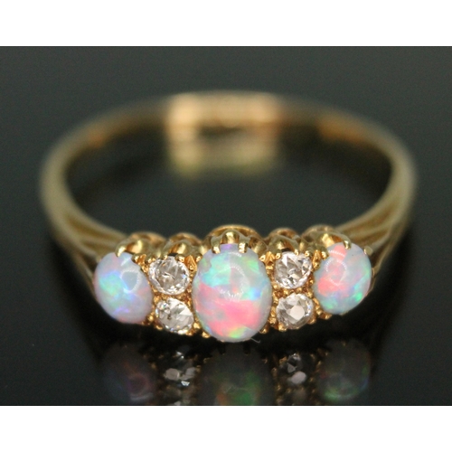 230 - An early 20th century precious opal and diamond ring, the central oval cabochon measuring approx. 5m... 