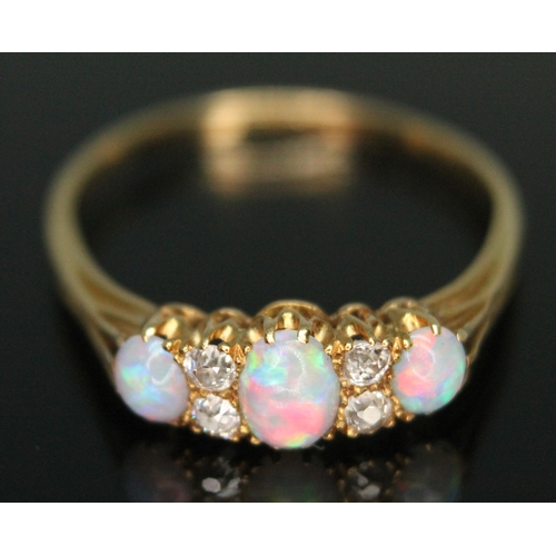 230 - An early 20th century precious opal and diamond ring, the central oval cabochon measuring approx. 5m... 