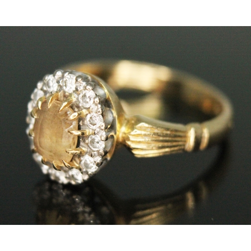 231 - A yellow topaz and diamond cluster ring, the central mixed cut stone measuring approx. 6mm x 4mm x 3... 