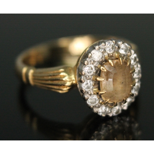 231 - A yellow topaz and diamond cluster ring, the central mixed cut stone measuring approx. 6mm x 4mm x 3... 