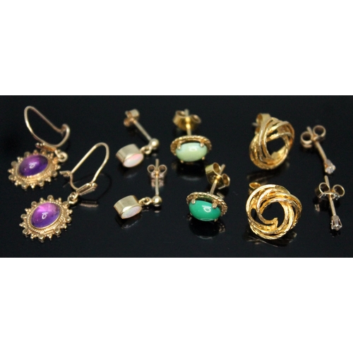 256 - Three pairs of hallmarked 9ct gold earrings comprising a pair set with amethyst cabochons, a pair se... 