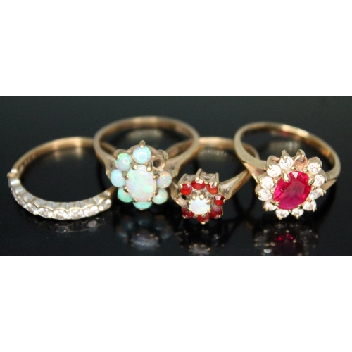 263 - A group of four rings comprising three hallmarked 9ct gold and another set with a synthetic ruby mar... 