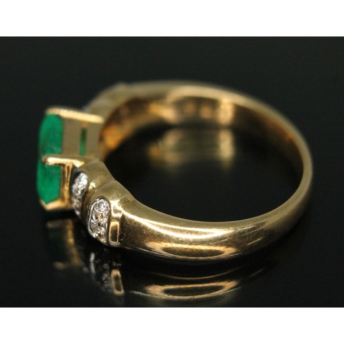 318 - An emerald and diamond ring, the central stone weighing approx. 1.34 carats, band marked '750', gros... 