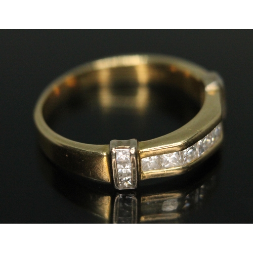 330 - A hallmarked 18ct gold diamond ring, set with 13 princess cut diamonds weighing approx. 0.75 carats ... 