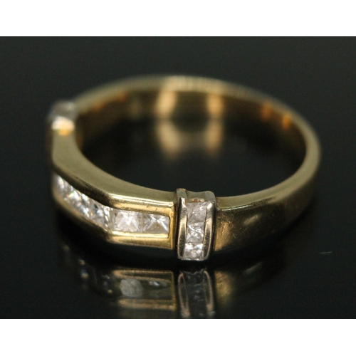 330 - A hallmarked 18ct gold diamond ring, set with 13 princess cut diamonds weighing approx. 0.75 carats ... 