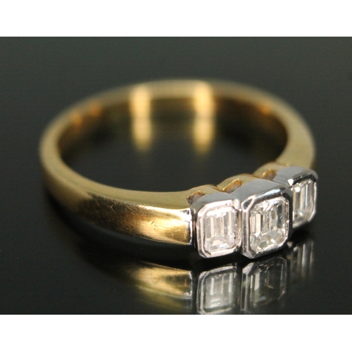 332 - An Art Deco style three bezel set stone diamond ring, the three emerald cut diamonds weighing approx... 