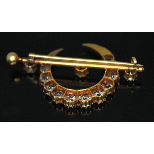 358 - A Victorian yellow metal brooch of crescent and bar form and set with old cut white sapphires, lengt... 