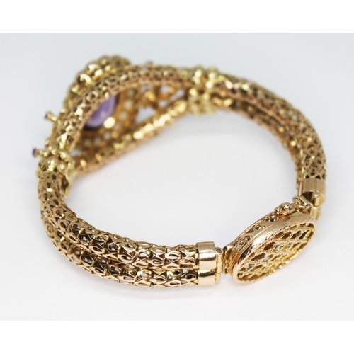 419 - A 9ct gold bracelet set with an oval cut amethyst weighing approx. 9.94 carats and surrounded by twe... 