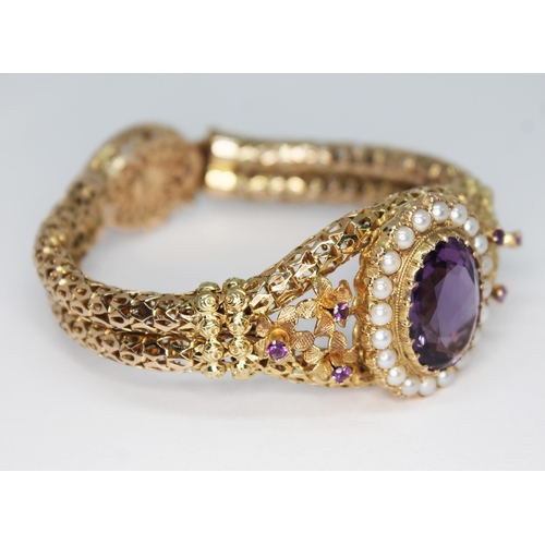 419 - A 9ct gold bracelet set with an oval cut amethyst weighing approx. 9.94 carats and surrounded by twe... 