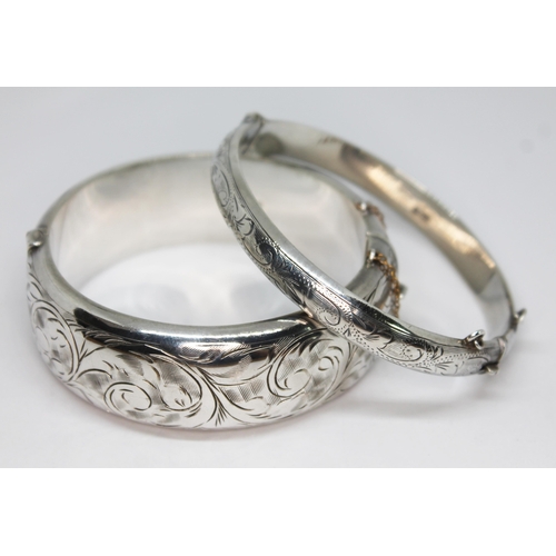 433 - Two bright cut engraved silver bangles, diam. approx. 5.5cm, wt. 51.21g.