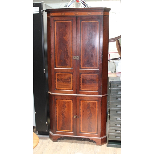 66D - A George III cross banded mahogany corner cabinet with shell inlay.