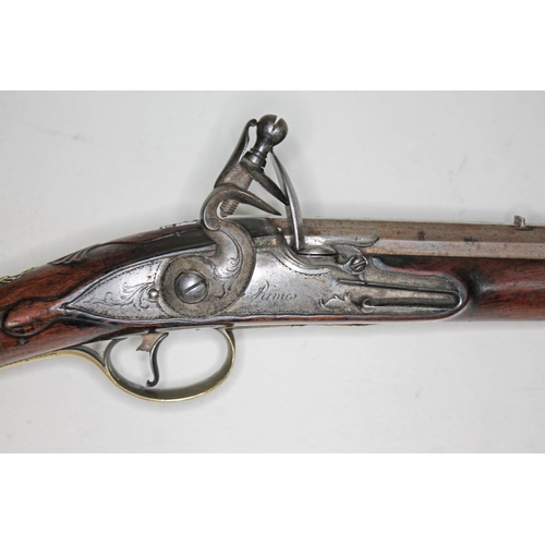 594 - A flintlock musket, circa 1800, 42cm octagonal barrel marked 'Rimes London', engraved plate also mar... 