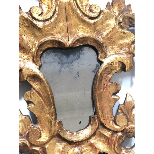 566 - A pair of carved gilt wood and gesso mirror, length 40cm each.