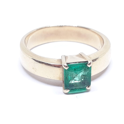 134 - A emerald ring, the rectangular emerald cut emerald weighing approx. 0.73 carats, the band marked '1... 