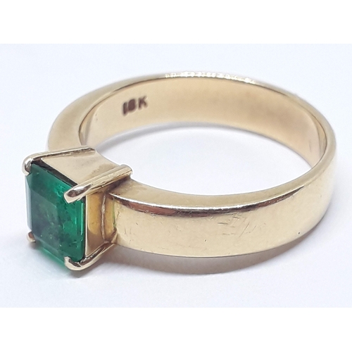 134 - A emerald ring, the rectangular emerald cut emerald weighing approx. 0.73 carats, the band marked '1... 