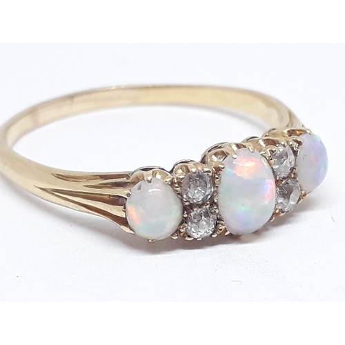 230 - An early 20th century precious opal and diamond ring, the central oval cabochon measuring approx. 5m... 