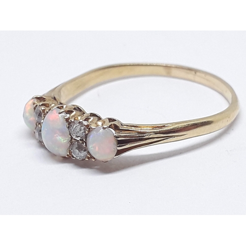 230 - An early 20th century precious opal and diamond ring, the central oval cabochon measuring approx. 5m... 