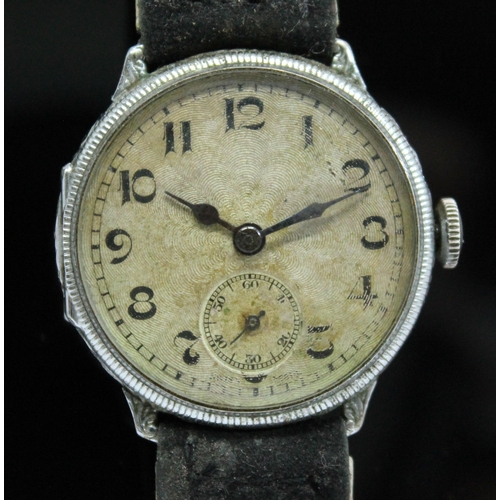 114 - A 1920s silver cased wristwatch having unsigned guilloche dial with Arabic numerals and seconds subs... 