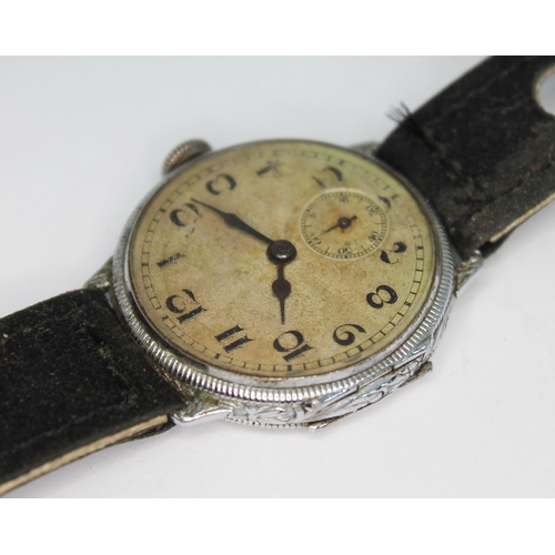 114 - A 1920s silver cased wristwatch having unsigned guilloche dial with Arabic numerals and seconds subs... 