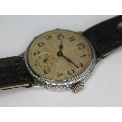 114 - A 1920s silver cased wristwatch having unsigned guilloche dial with Arabic numerals and seconds subs... 