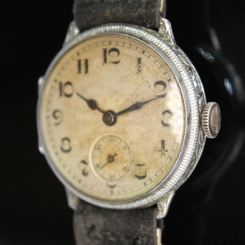 114 - A 1920s silver cased wristwatch having unsigned guilloche dial with Arabic numerals and seconds subs... 