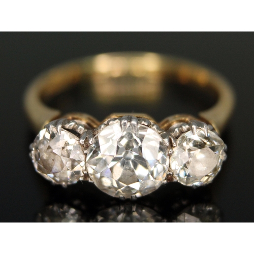 170 - An early 20th century three stone diamond ring, the three old European cut diamonds weighing approx....