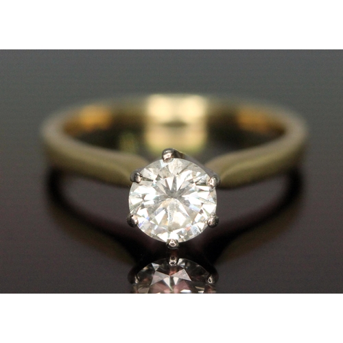 177 - A diamond solitaire ring, the modern round brilliant cut diamond weighing 0.69 carats, hallmarked 18... 