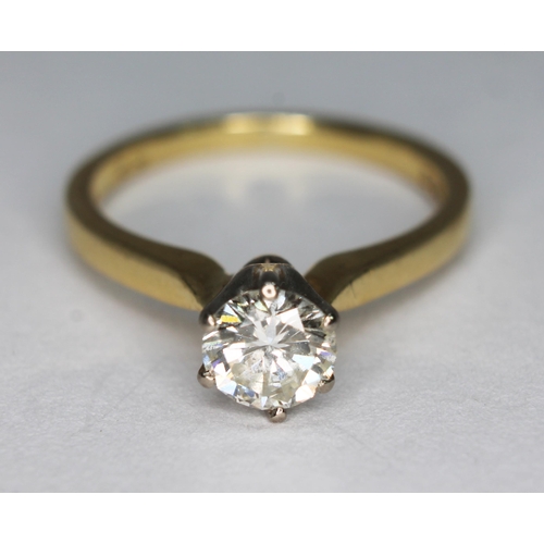 177 - A diamond solitaire ring, the modern round brilliant cut diamond weighing 0.69 carats, hallmarked 18... 