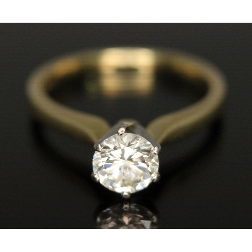 177 - A diamond solitaire ring, the modern round brilliant cut diamond weighing 0.69 carats, hallmarked 18... 