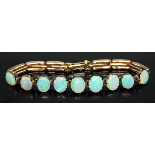 179 - A opal bracelet, featuring nine precious white oval opal cabochons ranging in size from approx. 9.03... 