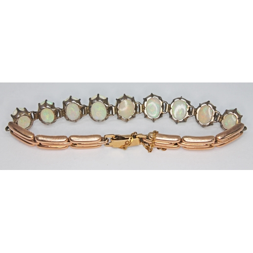 179 - A opal bracelet, featuring nine precious white oval opal cabochons ranging in size from approx. 9.03... 