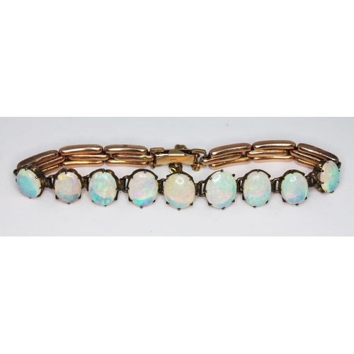 179 - A opal bracelet, featuring nine precious white oval opal cabochons ranging in size from approx. 9.03... 