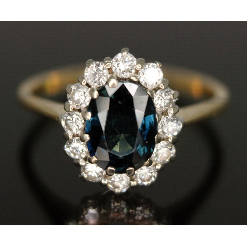 187 - A diamond and sapphire cluster ring, the central oval mixed cut sapphire weighing approx. 1.62 carat... 