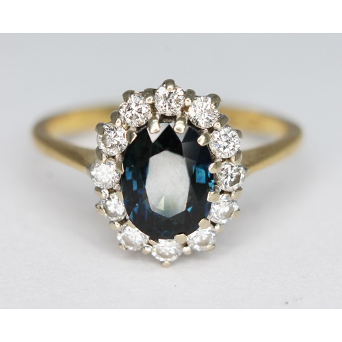 187 - A diamond and sapphire cluster ring, the central oval mixed cut sapphire weighing approx. 1.62 carat... 