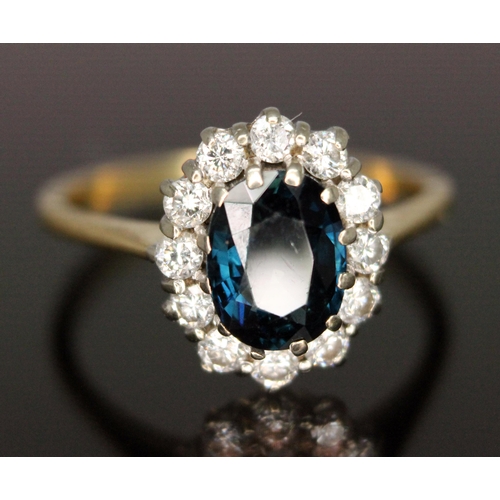 187 - A diamond and sapphire cluster ring, the central oval mixed cut sapphire weighing approx. 1.62 carat... 