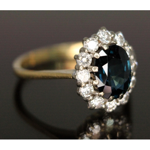 187 - A diamond and sapphire cluster ring, the central oval mixed cut sapphire weighing approx. 1.62 carat... 