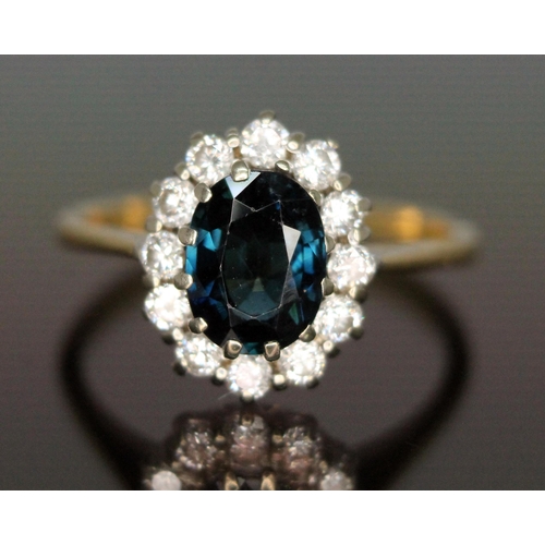 187 - A diamond and sapphire cluster ring, the central oval mixed cut sapphire weighing approx. 1.62 carat... 