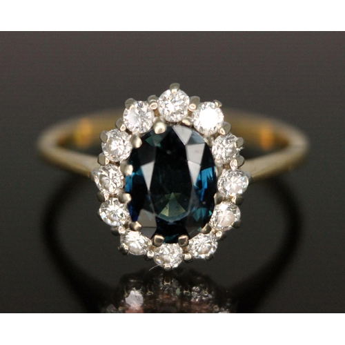 187 - A diamond and sapphire cluster ring, the central oval mixed cut sapphire weighing approx. 1.62 carat... 