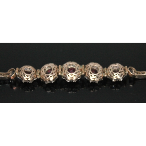 197 - A suite of garnet and white sapphire jewellery comprising a bracelet, necklace, ring and a pair of e... 