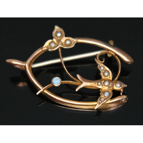 206 - An Edwardian hallmarked 9ct gold swallow brooch set with split pearls and a blue stone, gross wt. 1.... 