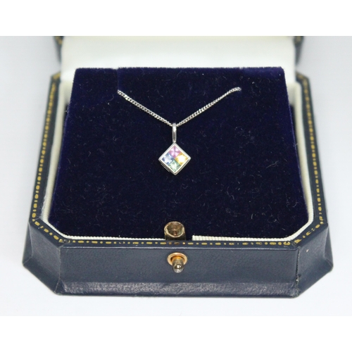 210 - A fancy sapphire pendant on chain, featuring four princess cut sapphires in blue, pink, yellow and g... 