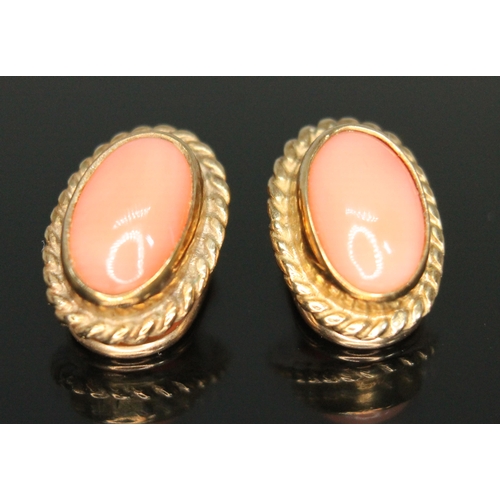 221 - A pair of hallmarked 9ct gold coral cabochon clip on earrings, length 13mm, gross wt. 3.59g.