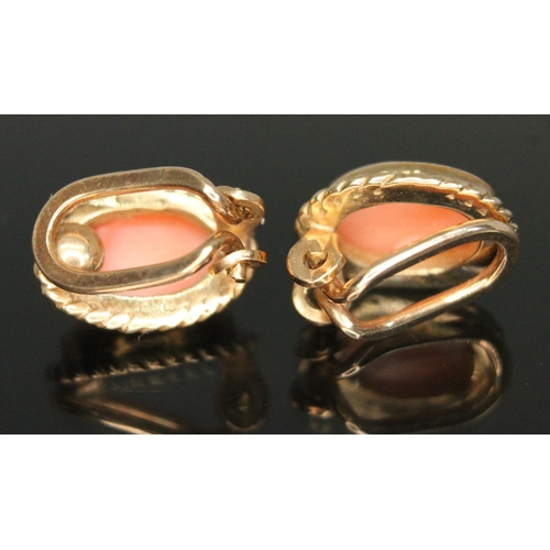 221 - A pair of hallmarked 9ct gold coral cabochon clip on earrings, length 13mm, gross wt. 3.59g.