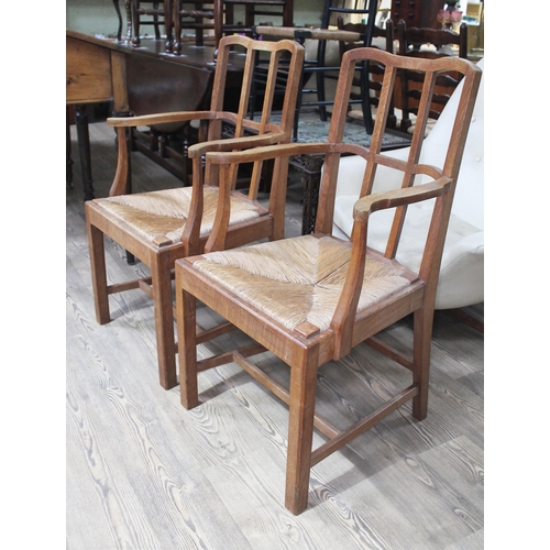 29 - A pair of Cotswold School Arts & Crafts oak armchairs by Theo Dalrymple after a design by Gimson.