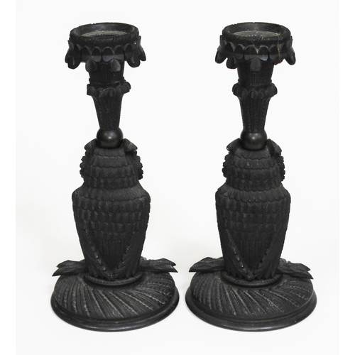 362 - A pair of Irish bog oak candlesticks modelled as owls, with sconce above having carved clovers, circ... 