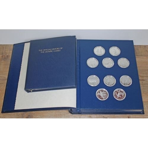 388 - The Official History of the Olympic Games coin set comprising fifty silver proof coins.