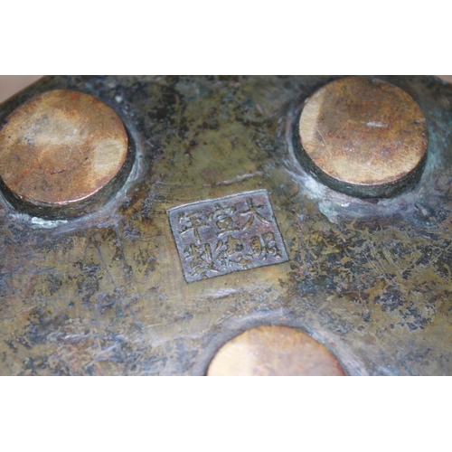 393 - A Chinese bronze censor, 19th century, hexagonal form with mythical dragon in relief, stood on three... 