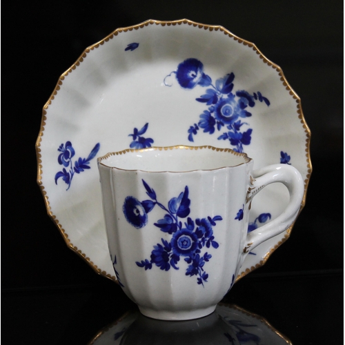 339 - A Worcester coffee cup and saucer, circa 1760, of fluted form and decorated in over-glaze blue bouqu... 