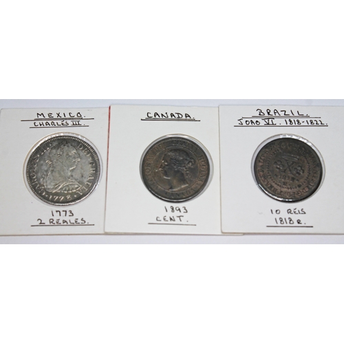 329 - A collection of world coins to include 1 x Hollandia wreck: Breales of Mexico 1743 silver chain, 1 x... 